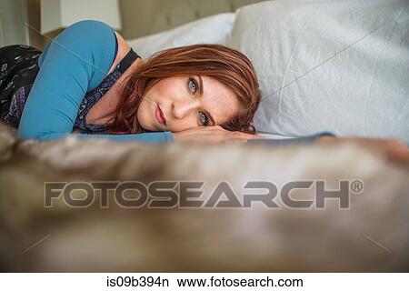 Picture - Woman lying in bed. Fotosearch