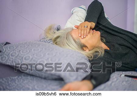 Woman lying in bed View Large Photo Image Stock Photograph - Woman lying in bed. Fotosearch
