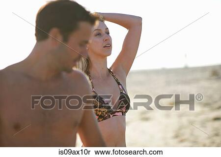 Woman on beach wearing bikini top, hand in hair looking away View Large Photo Image Stock Photography - Woman on beach wearing bikini top, hand in hair looking away. Fotosearch