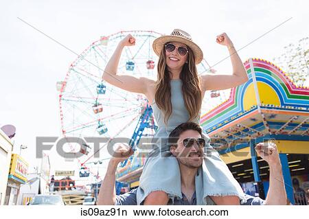Woman on friends shoulders, Coney island, Brooklyn, New York, USA View Large Photo Image Picture - Woman on friends shoulders, Coney island, Brooklyn, New York, USA. Fotosearch
