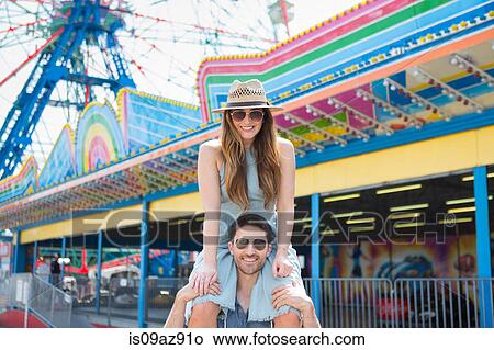 Woman on friends shoulders, Coney island, Brooklyn, New York, USA View Large Photo Image Picture - Woman on friends shoulders, Coney island, Brooklyn, New York, USA. Fotosearch