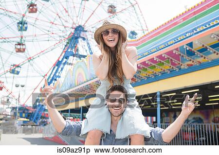 Woman on friends shoulders, Coney island, Brooklyn, New York, USA View Large Photo Image Stock Photography - Woman on friends shoulders, Coney island, Brooklyn, New York, USA. Fotosearch