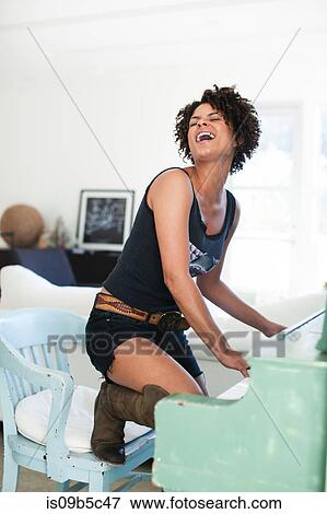 Stock Photo - Woman playing and singing at piano. Fotosearch