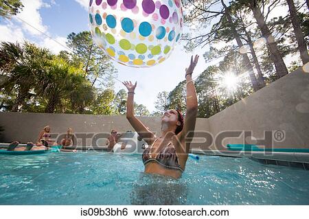 Woman playing throwing beach ball in swimming pool, Santa Rosa Beach, Florida, USA View Large Photo Image Stock Photograph - Woman playing throwing beach ball in swimming pool, Santa Rosa Beach, Florida, USA. Fotosearch