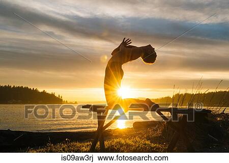 Woman practising yoga by lake at sunset View Large Photo Image Stock Image - Woman practising yoga by lake at sunset. Fotosearch