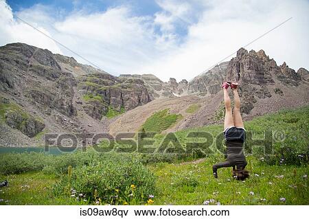 Woman practising yoga on meadow, Cathedral Lake, Aspen, Colorado View Large Photo Image Stock Photo - Woman practising yoga on meadow, Cathedral Lake, Aspen, Colorado. Fotosearch