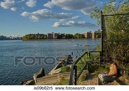 Woman reading on riverbank, New York, USA View Large Photo Image Stock Photography - Woman reading on riverbank, New York, USA. Fotosearch