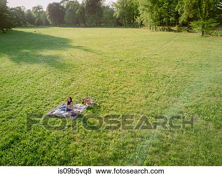 Woman relaxing on grass View Large Photo Image Stock Photo - Woman relaxing on grass. Fotosearch