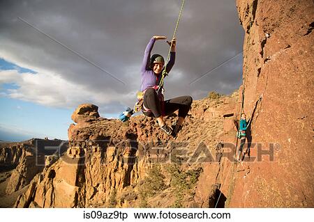 Woman rock climbing swinging on climbing rope View Large Photo Image Stock Photography - Woman rock climbing swinging on climbing rope. Fotosearch