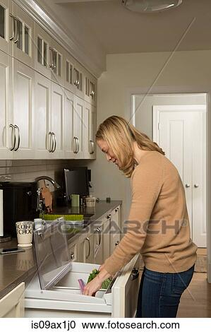 Woman searching for food in kitchen refrigerator View Large Photo Image Stock Image - Woman searching for food in kitchen refrigerator. Fotosearch