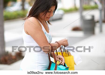 Woman searching her shopping bags, Los Angeles, California, USA View Large Photo Image Stock Photograph - Woman searching her shopping bags, Los Angeles, California, USA. Fotosearch