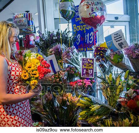 Stock Photograph - Woman shopping for flowers. Fotosearch