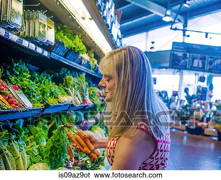 Woman shopping for vegetables in supermarket View Large Photo Image Stock Photograph - Woman shopping for vegetables in supermarket. Fotosearch
