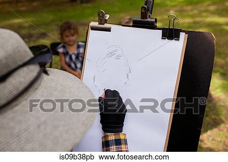 Woman sketching portrait of little girl in background View Large Photo Image Stock Image - Woman sketching portrait of little girl in background. Fotosearch