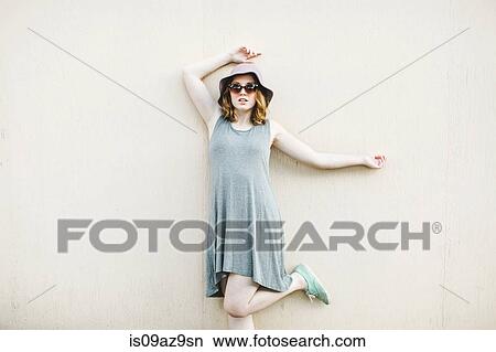 Woman standing on one leg looking at camera View Large Photo Image Picture - Woman standing on one leg looking at camera. Fotosearch