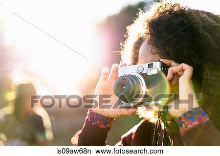 Woman taking photograph using slr camera View Large Photo Image Picture - Woman taking photograph using slr camera. Fotosearch
