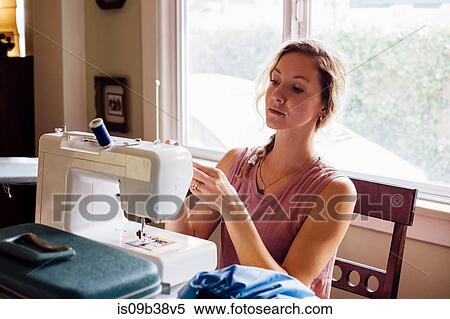 Woman threading sewing machine View Large Photo Image Stock Photography - Woman threading sewing machine. Fotosearch