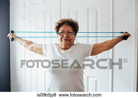 Woman using resistance band View Large Photo Image Stock Photo - Woman using resistance band. Fotosearch