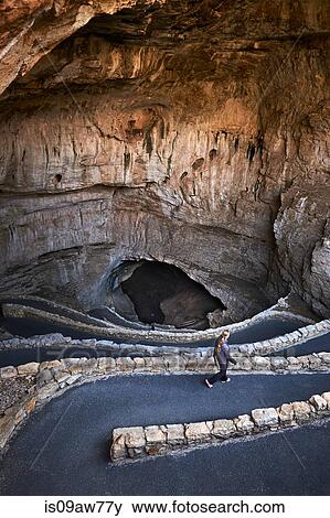 Woman walking downhill to cave, Carlsbad, New Mexico View Large Photo Image Stock Photo - Woman walking downhill to cave, Carlsbad, New Mexico. Fotosearch