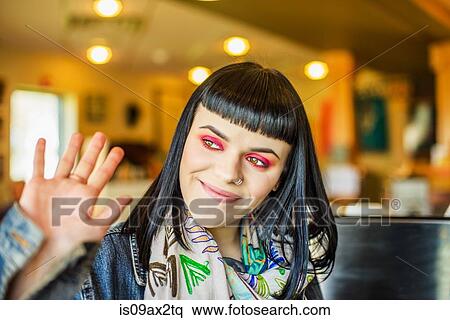 Woman waving, looking away smiling View Large Photo Image Stock Photography - Woman waving, looking away smiling. Fotosearch