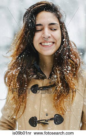 Woman wearing duffle coat in snow, eyes closed smiling View Large Photo Image Stock Photography - Woman wearing duffle coat in snow, eyes closed smiling. Fotosearch