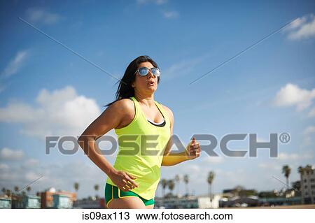 Woman wearing sunglasses jogging View Large Photo Image Stock Image - Woman wearing sunglasses jogging. Fotosearch