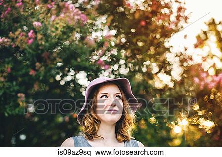 Woman wearing sunhat looking away smiling View Large Photo Image Stock Photography - Woman wearing sunhat looking away smiling. Fotosearch