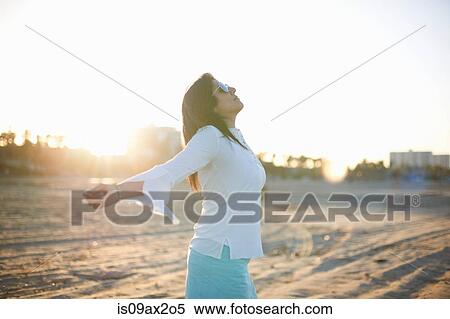 Woman with arms open on Santa Monica beach at sunset, Cresent City, California, USA View Large Photo Image Stock Photography - Woman with arms open on Santa Monica beach at sunset, Cresent City, California, USA. Fotosearch