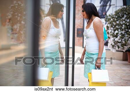 Woman with shopping bags window shopping, Los Angeles, California, USA View Large Photo Image Stock Photograph - Woman with shopping bags window shopping, Los Angeles, California, USA. Fotosearch