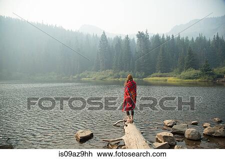 Woman wrapped in tartan blanket looking out over misty lake, Mount Hood National Forest, Oregon, USA View Large Photo Image Stock Image - Woman wrapped in tartan blanket looking out over misty lake, Mount Hood National Forest, Oregon, USA. Fotosearch