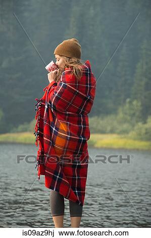 Woman wrapped in tartan blanket drinking coffee by lake, Mount Hood National Forest, Oregon, USA View Large Photo Image Stock Image - Woman wrapped in tartan blanket drinking coffee by lake, Mount Hood National Forest, Oregon, USA. Fotosearch
