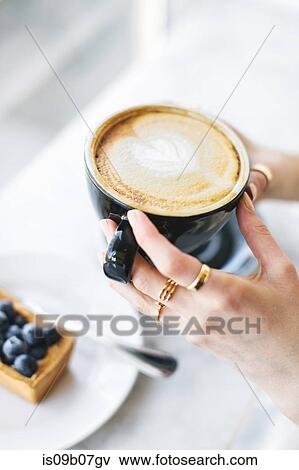 Woman's hands holding frothy coffee View Large Photo Image Stock Photo - Woman's hands holding frothy coffee. Fotosearch