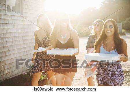 Women carrying pizza boxes smiling View Large Photo Image Stock Image - Women carrying pizza boxes smiling. Fotosearch