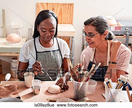 Women painting pottery in workshop View Large Photo Image Stock Image - Women painting pottery in workshop. Fotosearch