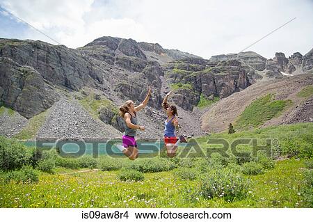 Women rejoicing in mid air, Cathedral Lake, Aspen, Colorado View Large Photo Image Picture - Women rejoicing in mid air, Cathedral Lake, Aspen, Colorado. Fotosearch