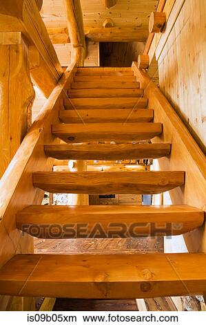 Wooden stairs leading upstairs in handcrafted red cedar log home, Quebec, Canada View Large Photo Image Picture - Wooden stairs leading upstairs in handcrafted red cedar log home, Quebec, Canada. Fotosearch
