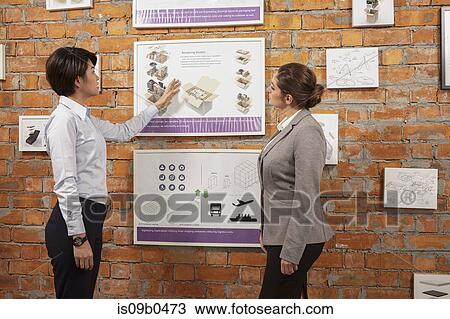 Worker showing framed product to manager on printing and packaging factory wall, China View Large Photo Image Stock Image - Worker showing framed product to manager on printing and packaging factory wall, China. Fotosearch