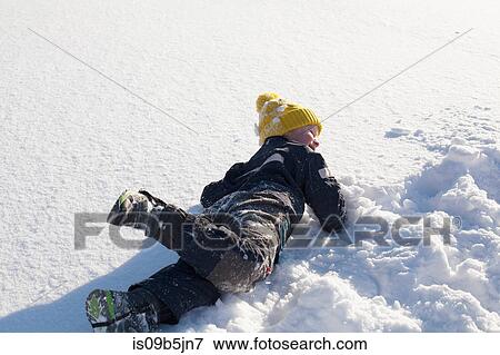 Young boy fooling around in snow View Large Photo Image Stock Photo - Young boy fooling around in snow. Fotosearch