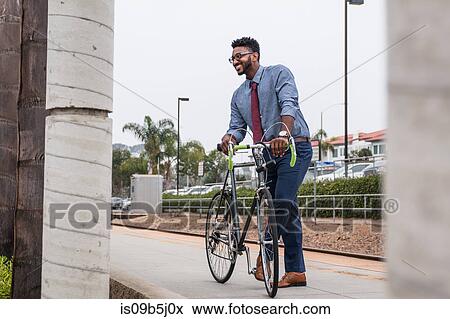 Young businessman cyclist on rail station platform View Large Photo Image Stock Photo - Young businessman cyclist on rail station platform. Fotosearch