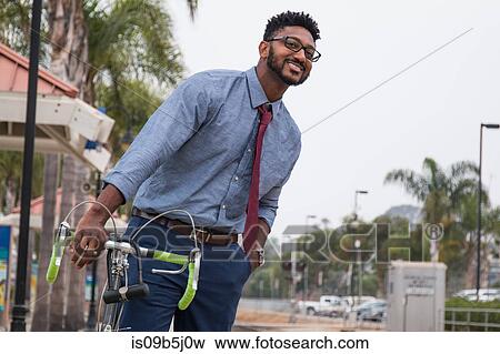 Young businessman cyclist watching rail station platform View Large Photo Image Stock Photo - Young businessman cyclist watching rail station platform. Fotosearch