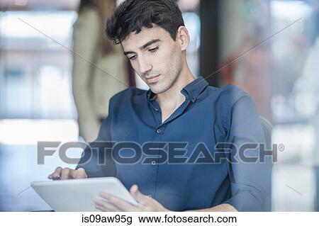 Young businessman using digital tablet View Large Photo Image Stock Image - Young businessman using digital tablet. Fotosearch