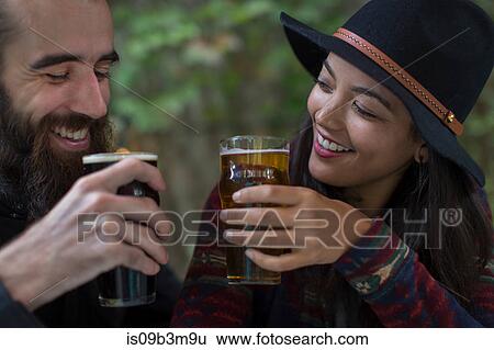 Young couple drinking beer in beer garden in evening, Brooklyn, New York, USA View Large Photo Image Stock Photograph - Young couple drinking beer in beer garden in evening, Brooklyn, New York, USA. Fotosearch