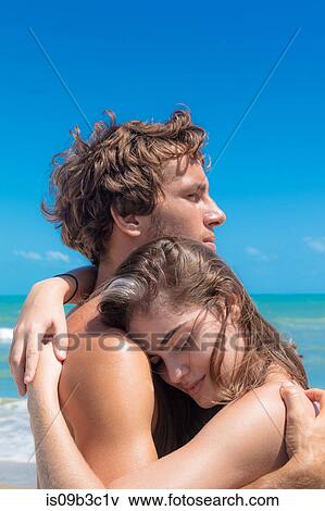 Stock Photo - Young couple hugging on beach, Taiba, Ceara, Brazil. Fotosearch
