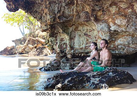 Young couple looking out from beach cave, Taiba, Ceara, Brazil View Large Photo Image Stock Photo - Young couple looking out from beach cave, Taiba, Ceara, Brazil. Fotosearch