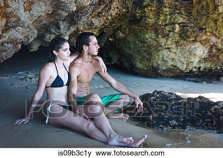 Young couple looking out from beach cave, Taiba, Ceara, Brazil View Large Photo Image Stock Photo - Young couple looking out from beach cave, Taiba, Ceara, Brazil. Fotosearch