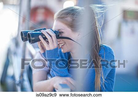 Young couple looking through binoculars on tourist boat trip, Cape Town, South Africa View Large Photo Image Stock Photo - Young couple looking through binoculars on tourist boat trip, Cape Town, South Africa. Fotosearch