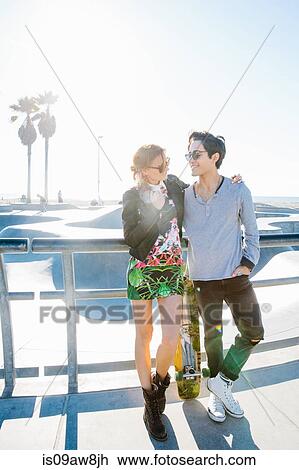 Young couple standing together, outdoors, face to face, smiling View Large Photo Image Stock Image - Young couple standing together, outdoors, face to face, smiling. Fotosearch