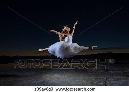 Young female ballet dancer leaping over Bonneville Salt Flats at night, Utah, USA View Large Photo Image Stock Photo - Young female ballet dancer leaping over Bonneville Salt Flats at night, Utah, USA. Fotosearch