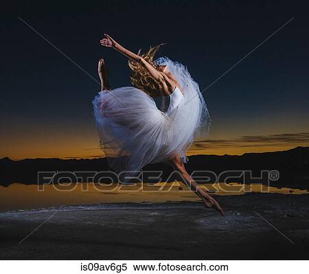 Young female ballet dancer leaping over Bonneville Salt Flats at dusk, Utah, USA View Large Photo Image Stock Photography - Young female ballet dancer leaping over Bonneville Salt Flats at dusk, Utah, USA. Fotosearch