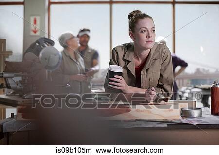 Young female carpenter daydreaming whilst painting wood stain in furniture making workshop View Large Photo Image Picture - Young female carpenter daydreaming whilst painting wood stain in furniture making workshop. Fotosearch